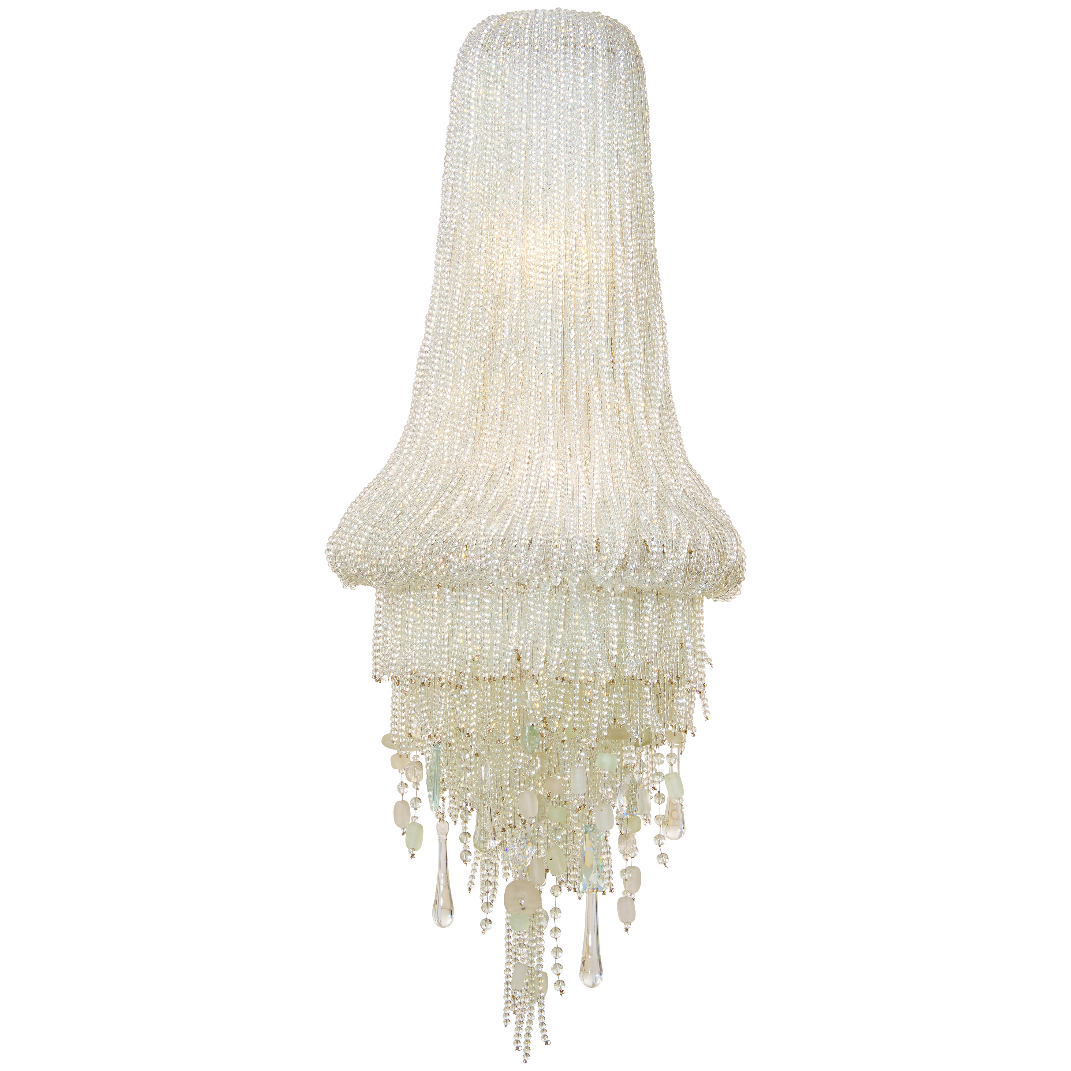 The Crystal Reign wall sconce combines contemporary elegance with coastal charm through cascading crystal beads and sea glass accents. Its polished nickel finish and substantial 33-inch height create a dramatic statement piece.